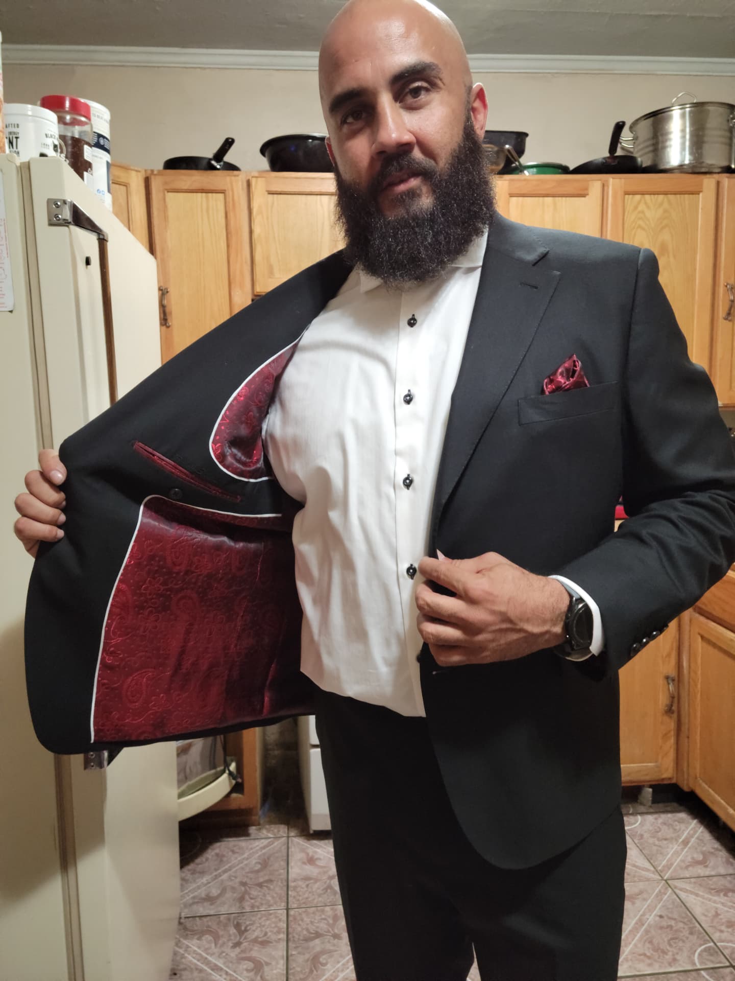 Black custom suit jacket opened to show a burgundy paisley lining