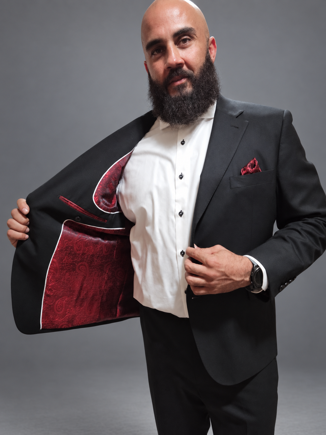 Black custom suit jacket opened to show a burgundy paisley lining
